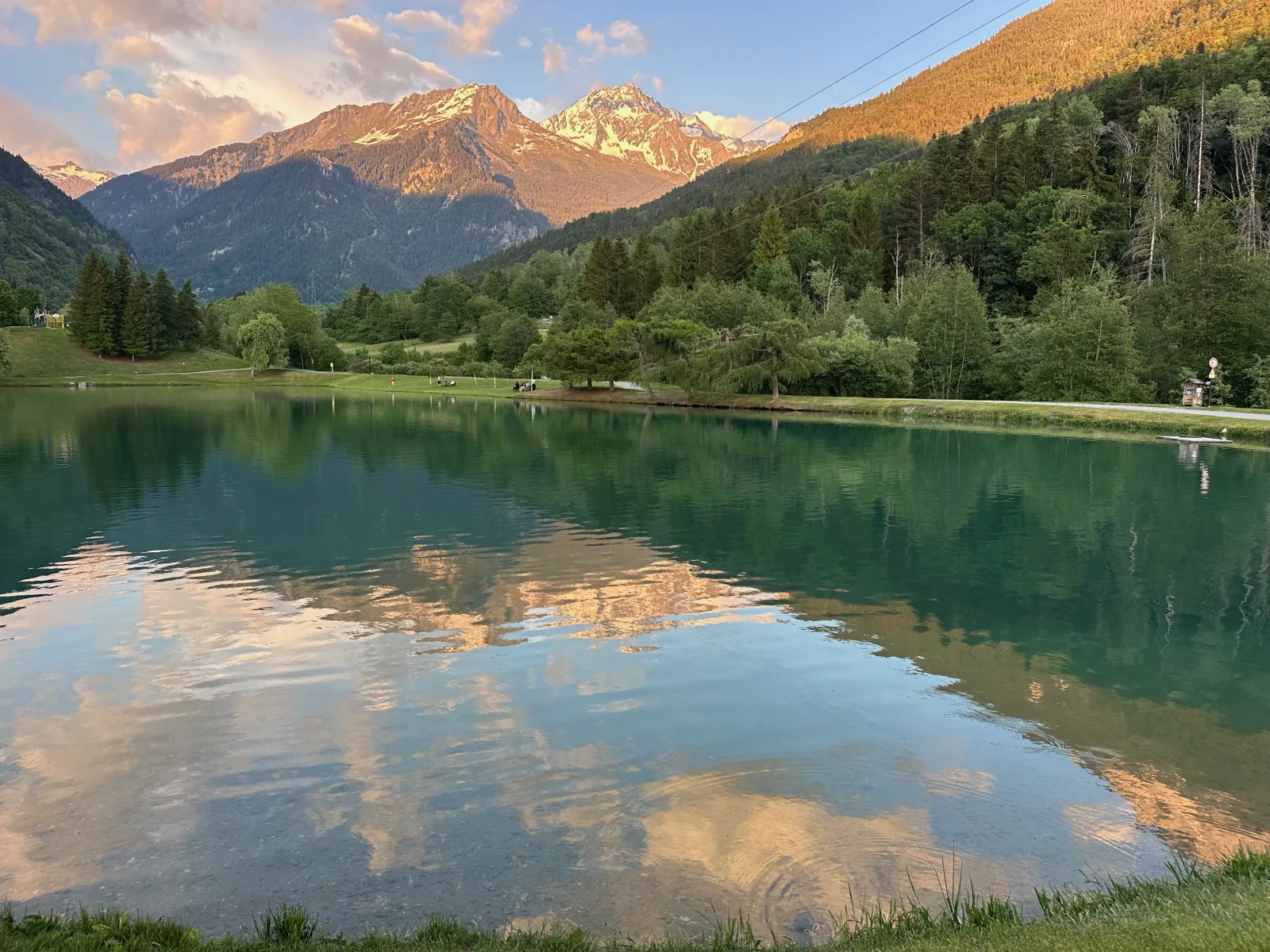 The Bozel lake at sunset, snow-capped Vanoise peaks reflected in the water